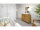 Charming Bedroom featuring a crib, carpeted floor, whitewashed dresser, decorative lamp, and framed mirror at 6165 Helens Rest Ln, Lincolnton, NC 28092