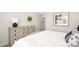 Bright bedroom featuring a whitewashed dresser, decorative lamp, picture frame, and white and gray bedding at 6165 Helens Rest Ln, Lincolnton, NC 28092