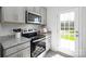 Well-equipped kitchen features stainless steel appliances, sleek cabinets and a door to the backyard at 6165 Helens Rest Ln, Lincolnton, NC 28092