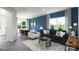 Open-concept living room featuring large windows, stylish furniture, and sleek flooring at 6165 Helens Rest Ln, Lincolnton, NC 28092