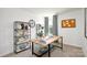 Bright office space featuring a wood desk, shelving, and stylish black and white patterned curtains at 6165 Helens Rest Ln, Lincolnton, NC 28092