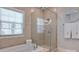 Bright bathroom with a bathtub and glass shower at 6231 Wakehurst Rd, Charlotte, NC 28226