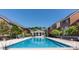 Beautiful community pool surrounded by brick townhomes on a bright sunny day at 6231 Wakehurst Rd, Charlotte, NC 28226