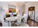 Beautiful dining room with hardwood floors, large mirror, and table with seating for six at 6231 Wakehurst Rd, Charlotte, NC 28226