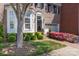 Charming brick home featuring a bay window, manicured lawn, and attached garage at 6231 Wakehurst Rd, Charlotte, NC 28226