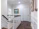 Elegant hallway with dark wood floors and white wainscoting at 6231 Wakehurst Rd, Charlotte, NC 28226