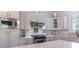 Modern kitchen featuring stainless steel appliances, white cabinets, and sleek countertops at 6231 Wakehurst Rd, Charlotte, NC 28226