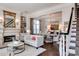 Bright living room featuring a fireplace, built-in shelving, and seamless access to the dining area at 6231 Wakehurst Rd, Charlotte, NC 28226