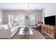 Cozy living room featuring plush seating, a large television, and natural light at 6231 Wakehurst Rd, Charlotte, NC 28226
