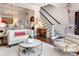 Elegant living room with hardwood floors, staircase, and an open layout to the dining area at 6231 Wakehurst Rd, Charlotte, NC 28226