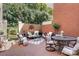 Charming outdoor patio with comfortable seating, lush greenery, and brick accents at 6231 Wakehurst Rd, Charlotte, NC 28226