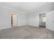 Empty bedroom with neutral carpet and two entry doors at 6272 Raven Rock Dr, Denver, NC 28037