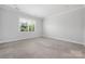 Empty bedroom with neutral carpet and a large window at 6272 Raven Rock Dr, Denver, NC 28037