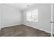 Neutral bedroom with wood-look floors, white trim, and a double window at 6272 Raven Rock Dr, Denver, NC 28037