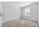 Neutral bedroom with a gray carpet, white trim, and a window with blinds at 6272 Raven Rock Dr, Denver, NC 28037