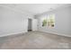 Empty bedroom with neutral carpet and a large window at 6272 Raven Rock Dr, Denver, NC 28037