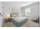 Bright bedroom with a blue bed frame, white walls, and a beige patterned rug at 6272 Raven Rock Dr, Denver, NC 28037
