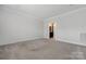 Empty bedroom with neutral carpet and a view into the bathroom at 6272 Raven Rock Dr, Denver, NC 28037