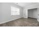 Bedroom with wood-look floors, white trim, and a door to the outside at 6272 Raven Rock Dr, Denver, NC 28037