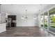 Bright, open dining and kitchen area with hardwood floors, stainless steel appliances, and a sliding glass door at 6272 Raven Rock Dr, Denver, NC 28037