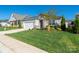 Well-maintained single-story home with lush green lawn, stone details, and an attached two-car garage at 6272 Raven Rock Dr, Denver, NC 28037