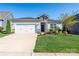 Charming single-story home featuring stone accents, a well-manicured lawn, and a two-car garage at 6272 Raven Rock Dr, Denver, NC 28037
