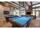 Enjoyable game room with pool tables, lounge seating, and a TV for social gatherings at 6272 Raven Rock Dr, Denver, NC 28037