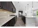 Spacious kitchen with dark wood cabinetry, stainless steel appliances and granite countertops at 6272 Raven Rock Dr, Denver, NC 28037