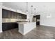 Modern kitchen showcasing stainless steel appliances, a center island, and hardwood flooring at 6272 Raven Rock Dr, Denver, NC 28037