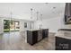 Bright open kitchen features a center island, stainless steel appliances, and hardwood flooring at 6272 Raven Rock Dr, Denver, NC 28037