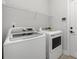 Clean laundry room with white appliances and wire shelving at 6272 Raven Rock Dr, Denver, NC 28037