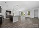 Spacious living area features hardwood floors, stainless appliances, kitchen island, and abundant natural light at 6272 Raven Rock Dr, Denver, NC 28037
