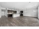 Open-concept living space featuring hardwood floors, stainless steel appliances, and a center kitchen island at 6272 Raven Rock Dr, Denver, NC 28037