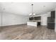 Expansive living space with hardwood floors, recessed lighting, stainless appliances, and open kitchen layout at 6272 Raven Rock Dr, Denver, NC 28037