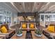 Lobby lounge area features decorative lighting, leather seating, and sleek tables with plant decor at 6272 Raven Rock Dr, Denver, NC 28037
