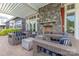 Relaxing outdoor patio featuring comfortable wicker furniture and a stone fireplace under a pergola at 6272 Raven Rock Dr, Denver, NC 28037