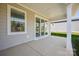 Covered patio features gray siding, a concrete floor, and sliding glass doors to the home's interior at 6272 Raven Rock Dr, Denver, NC 28037