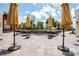 Outdoor patio with tables, chairs, umbrellas, and beautiful landscaping for dining and relaxing at 6272 Raven Rock Dr, Denver, NC 28037