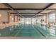 Indoor pool area with exposed wooden beams, natural light, and calming atmosphere for relaxation at 6272 Raven Rock Dr, Denver, NC 28037