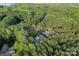 An aerial shot of a home surrounded by dense green forest and winding roads at 7351 Bay Cove Ct, Denver, NC 28037