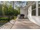 Spacious back deck with a grill, offering an outdoor cooking and dining space with wooded views at 7351 Bay Cove Ct, Denver, NC 28037