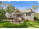 Backyard with a stone patio, fire pit, outdoor seating, and a covered porch at 7351 Bay Cove Ct, Denver, NC 28037