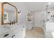 Bright bathroom featuring double vanities, decorative mirrors, shiplap accent wall and a glass-enclosed shower at 7351 Bay Cove Ct, Denver, NC 28037