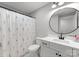 Fresh bathroom featuring floral shower curtain, vanity with round mirror and patterned tile floor, bright and clean at 7351 Bay Cove Ct, Denver, NC 28037
