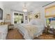 Charming bedroom with neutral tones, windows with tree views, bamboo shades, chandelier and stylish furnishings at 7351 Bay Cove Ct, Denver, NC 28037