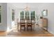 Inviting dining room with natural light, farmhouse table, and elegant chandelier at 7351 Bay Cove Ct, Denver, NC 28037