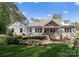 Beautiful backyard with a patio, fire pit area, and lush landscaping surrounding a modern home at 7351 Bay Cove Ct, Denver, NC 28037