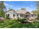 Well-maintained home exterior with covered porch, patio, and landscaped backyard at 7351 Bay Cove Ct, Denver, NC 28037