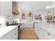 Bright kitchen with white cabinets, open shelving, and stainless steel appliances at 7351 Bay Cove Ct, Denver, NC 28037