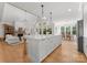 Spacious open-concept kitchen with an island, dining area, and a seamless flow into the living room at 7351 Bay Cove Ct, Denver, NC 28037
